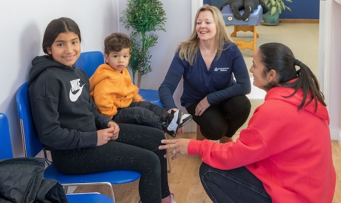 smiling kids in the chiropractic office